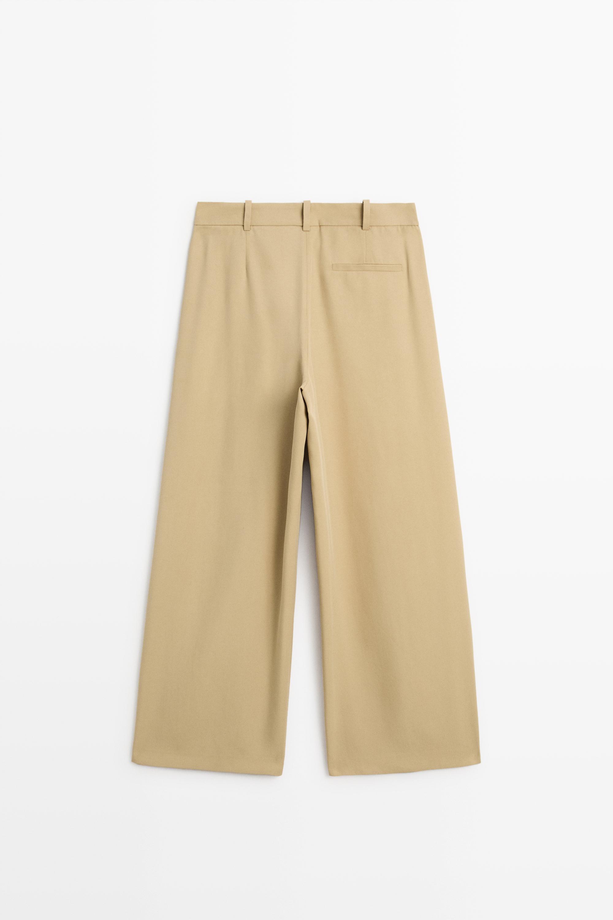 Flowing pleated pants with button detail